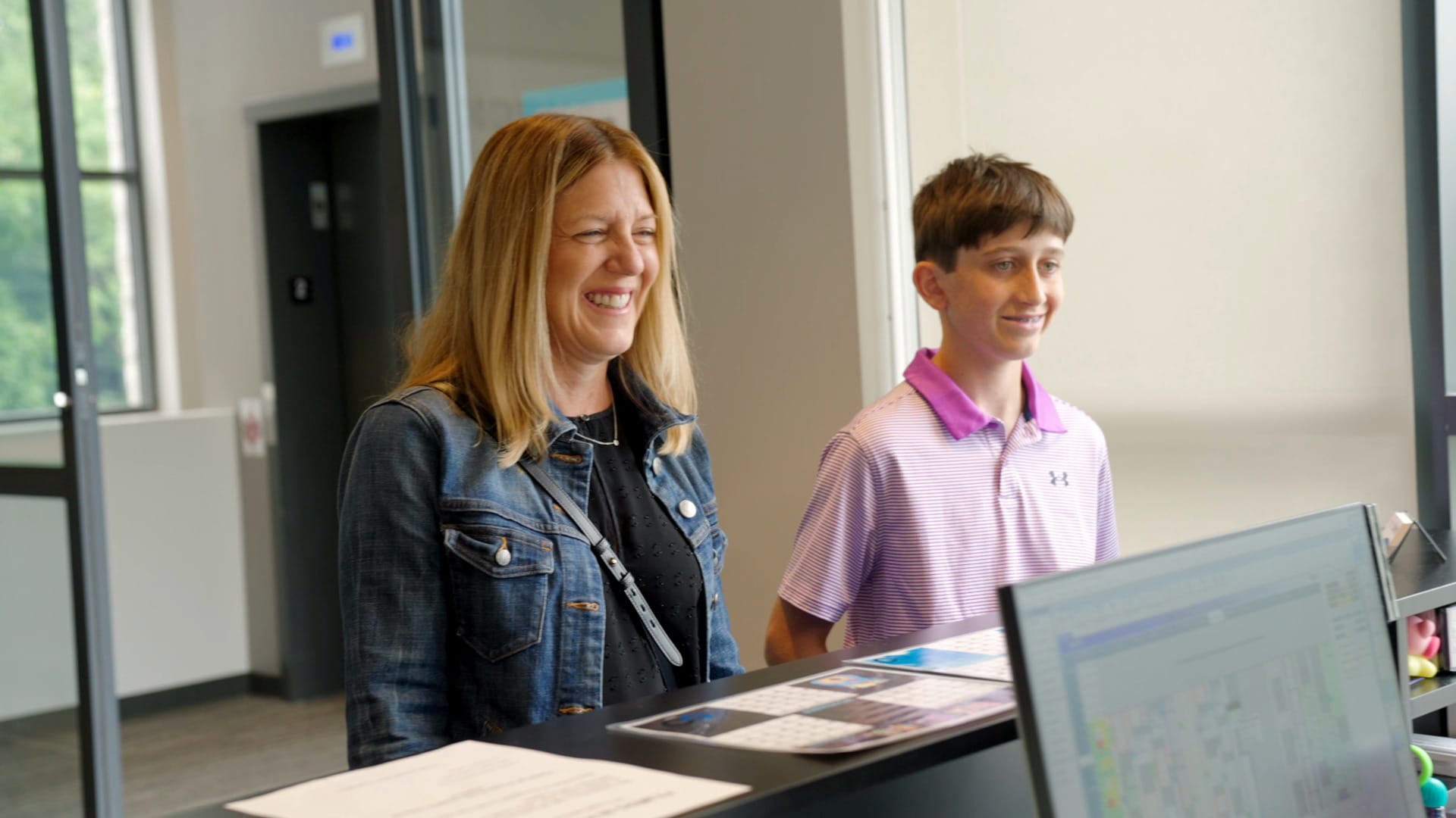 smiling patients at front desk