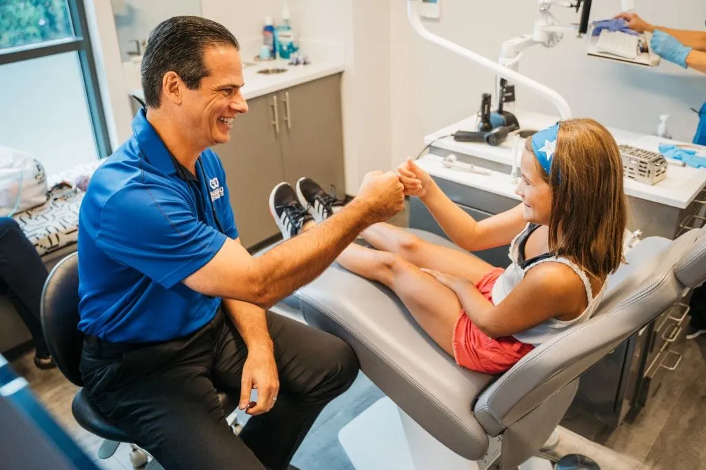 Dr. Caggiano fist bumping patient